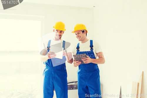 Image of builders with tablet pc and equipment indoors