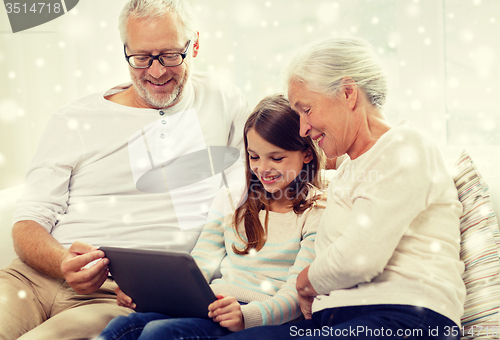 Image of smiling family with tablet pc at home