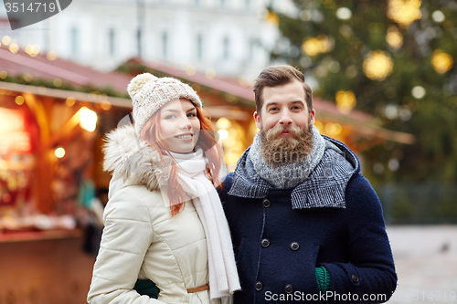 Image of happy couple walking in old town