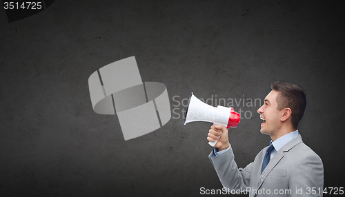 Image of happy businessman in suit speaking to megaphone