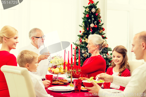 Image of smiling family having holiday dinner at home