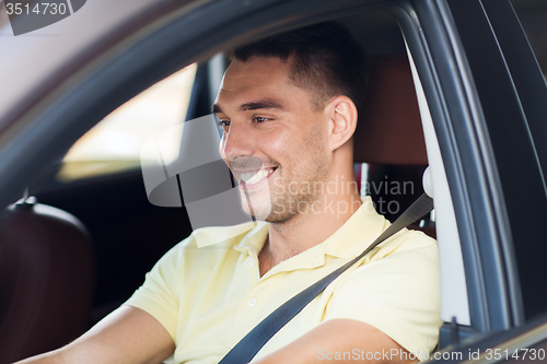 Image of happy smiling man driving car outdoors