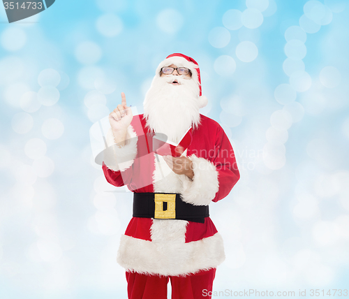 Image of man in costume of santa claus with notepad