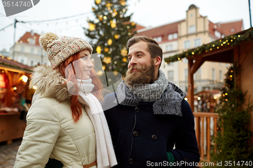 Image of happy couple walking in old town