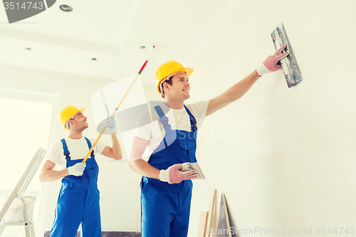 Image of group of builders with tools indoors