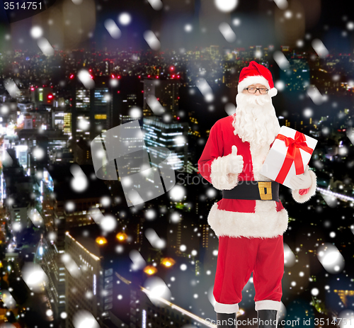 Image of man in costume of santa claus with gift box