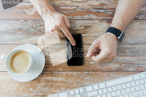 Image of close up of hands with smart phone and watch