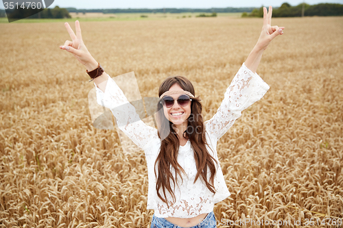 Image of smiling young hippie woman on cereal field