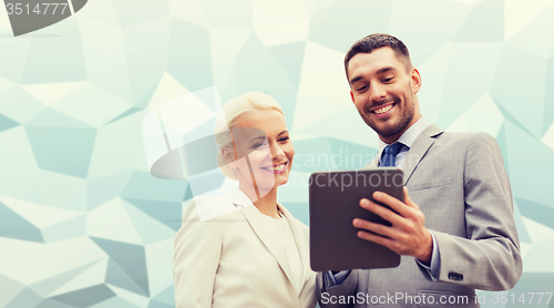 Image of smiling businessmen with tablet pc outdoors