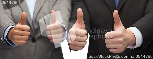 Image of businessman and businesswoman showing thumbs up