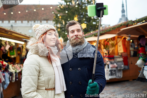 Image of couple taking selfie with smartphone in old town