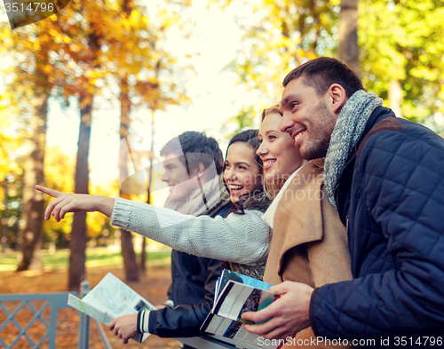 Image of group of friends with map outdoors