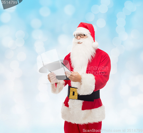 Image of man in costume of santa claus with notepad