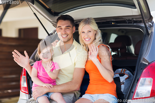 Image of happy family with hatchback car at home parking