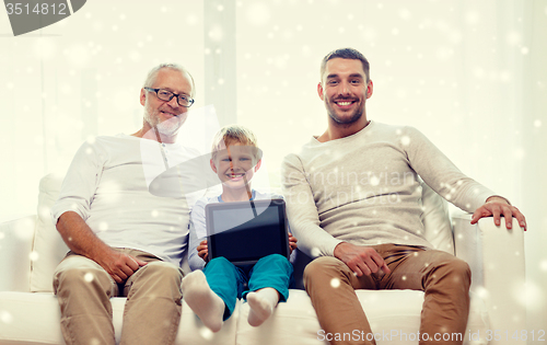 Image of smiling family with tablet pc at home