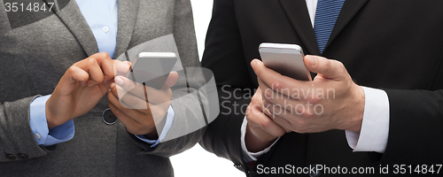 Image of businessman and businesswoman with smartphones