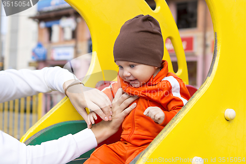 Image of Baby boy on children's slide