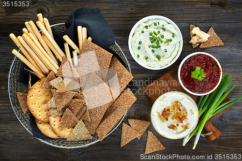 Image of various dip sauces and bowl of bread cookies