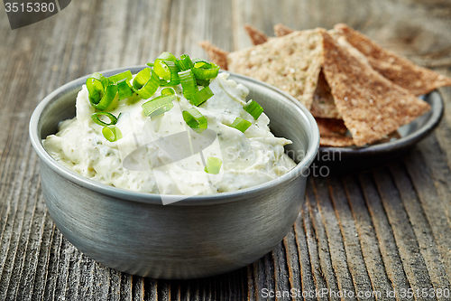 Image of cream cheese with green onions and herbs