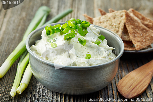 Image of cream cheese with green onions and herbs