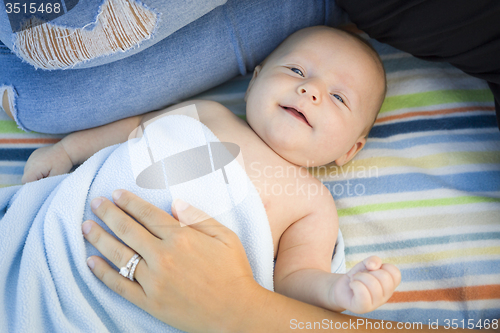 Image of Little Baby Boy Wrapped In His Blanket Resting With Mommy