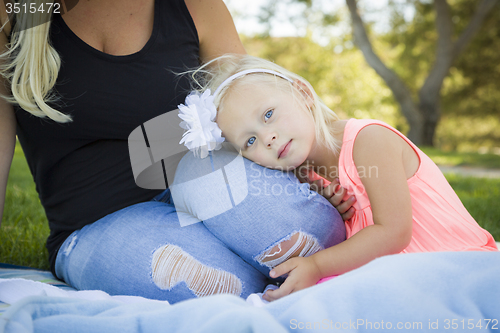 Image of Beautiful Young Girl Resting on Her Mommy\'s Lap At Park