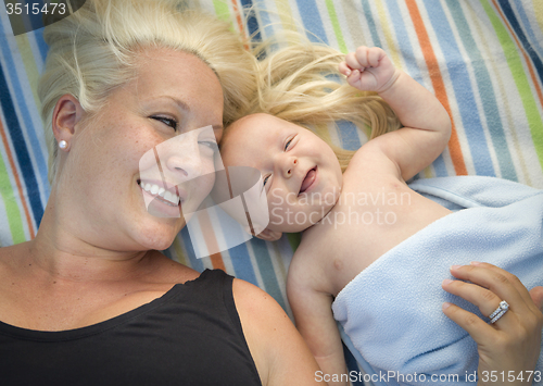 Image of Little Baby Boy Wrapped In His Blanket Resting With Mommy