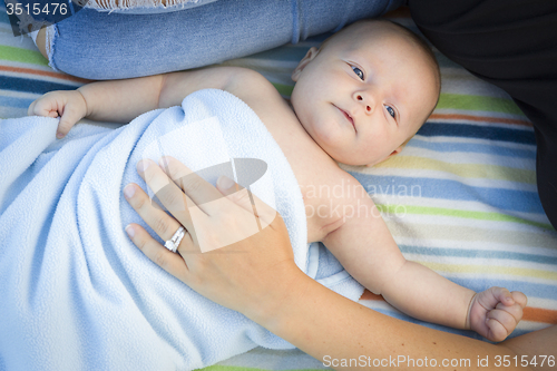 Image of Little Baby Boy Wrapped In His Blanket Resting With Mommy