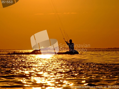 Image of Silhouette of a kite-surf on waves of a gulf on a sunset 2