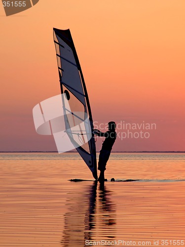 Image of Silhouette of a wind-surfer on waves of a gulf on a sunset 3