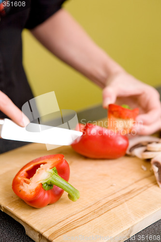 Image of Female Slicing a Red Pepper