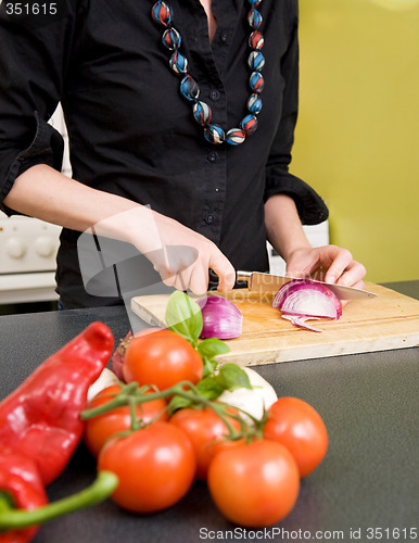 Image of Woman Cutting an Onion