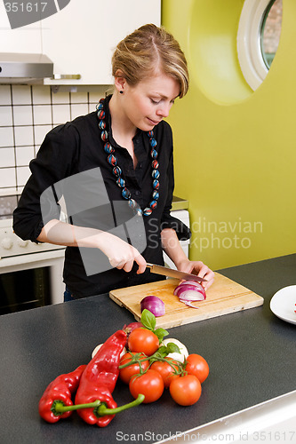 Image of Woman Slicing a Red Onion