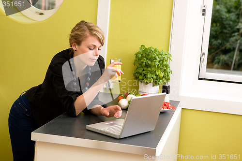 Image of Using Laptop in Kitchen