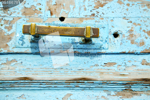 Image of rusty metal nail dirty stripped paint in the blue  