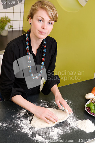 Image of Young Woman Making Pizza Dough