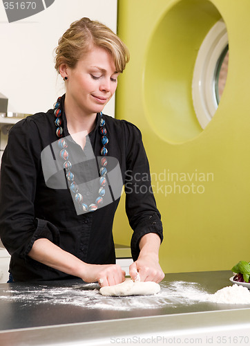 Image of Young Woman Happily Making Pizza Dough