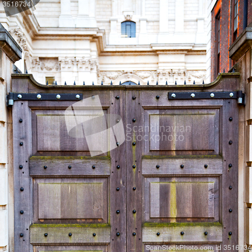 Image of brown wooden parliament in london old  door and marble antique  