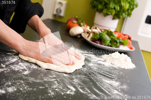 Image of Hands making pizza - detail