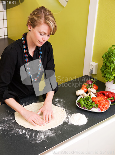 Image of Young Woman Making Pizza Dough