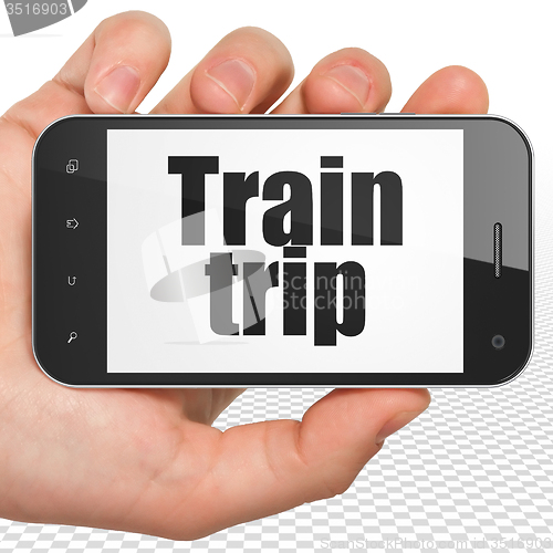 Image of Tourism concept: Hand Holding Smartphone with Train Trip on display