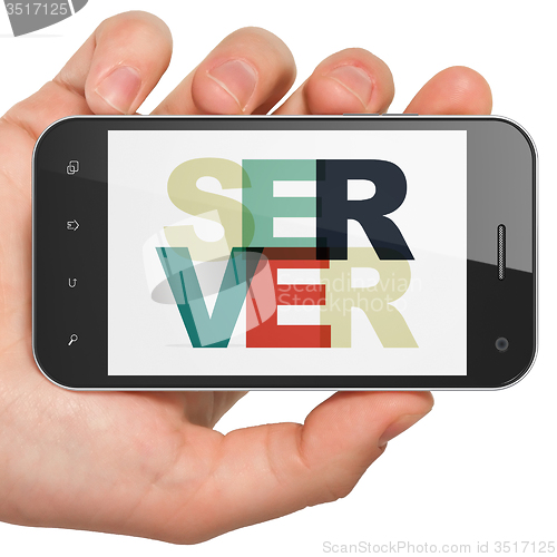 Image of Web design concept: Hand Holding Smartphone with Server on  display