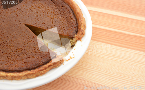 Image of Close-up of cut pumpkin pie with slice taken