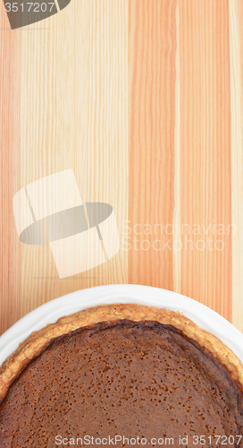 Image of Thanksgiving pumpkin pie on wood