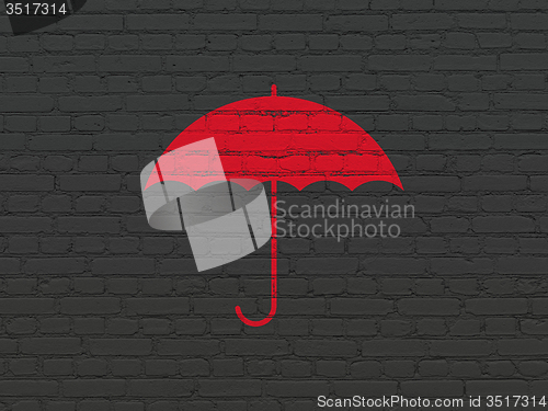 Image of Security concept: Umbrella on wall background