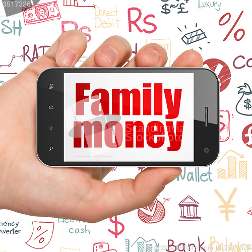 Image of Banking concept: Hand Holding Smartphone with Family Money on display