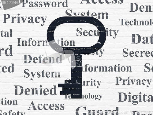 Image of Protection concept: Key on wall background