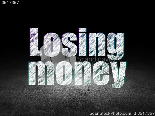 Image of Currency concept: Losing Money in grunge dark room