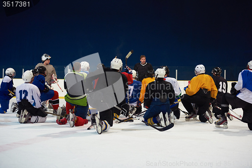 Image of ice hockey players team meeting with trainer