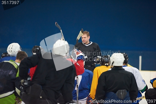 Image of ice hockey players team meeting with trainer